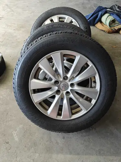 Michelin x ice tires 225/65/17 center bore is 64.1 mm with alloy wheels 70% left remaining, came off...