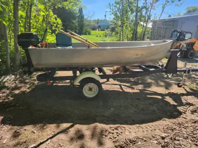 SOLD PENDING 12' aluminum fishing boat with 9.8 mercury 2 stroke engine and trailer has oars,anchor,...