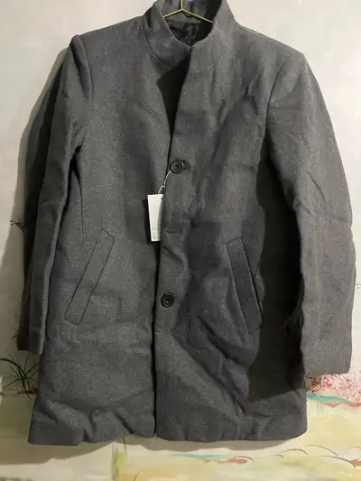 This brand new stylish woollen grey overcoat is brand new with tags, perfect for adding a touch of s...