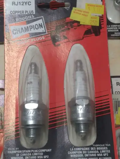 Unopened packs of vintage Champion spark plugs from the 1980's: RF9YC- 43 packs RJ12YC- 27 packs RV1...