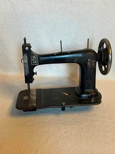 This antique machine is likely a Singer. It has J. Kindree St. Thomas Ontario etched on the thread c...