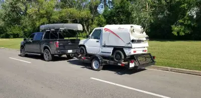 This car hauler features a hydraulic lift and lower system for easy loading and unloading; it's used...