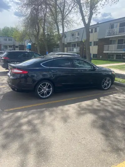 2013 Ford Fusion Titanium AWD – $7000 obo Black sedan with 188,000 km. Loaded with leather heated se...