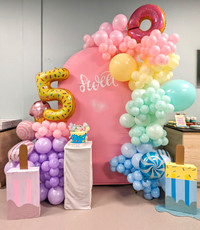 Candy-themed balloon garland and backdrop in beautiful pastels
