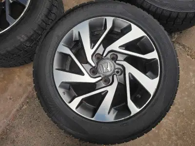 Set of 4 original 16 inches Honda civic rims with winter tires on them 215/55/R16. Rims have some cu...