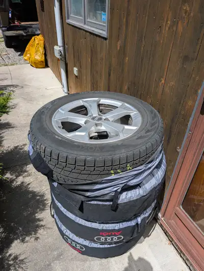 Four Yokohama 215/65/17 Ice Guard Winter Tires mounted on Audi Aluminum Alloy Rims. Rims are part nu...