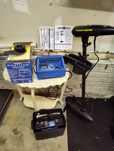 Minn Kota 33 lbs thrust trolling motor with used spare prop. Nautalis Battery charger and matching b...
