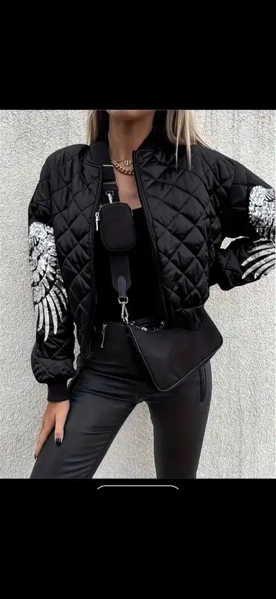 This is a stylish black quilted bomber jacket✨️ It features a unique wing design on the sleeves, add...