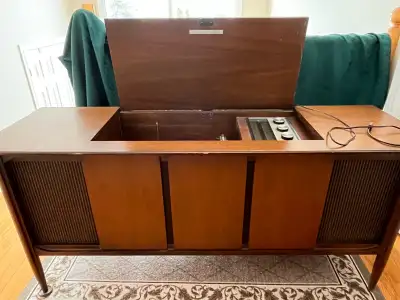 Charming vintage turntable and radio console. This piece is not currently working and is being sold...
