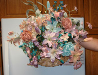 Artificial floral arrangement in hanging wicker basket