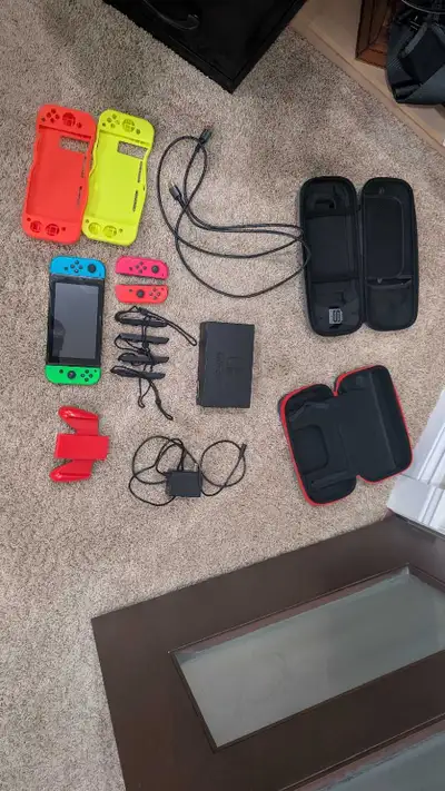 This Nintendo Switch console is in good pre-owned condition and comes with a variety of accessories...