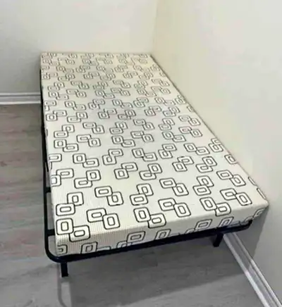 This twin mattress offers firm support and a clean, patterned cover; it is ideal for a child's room...