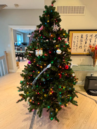 7.5' tall artificial Christmas tree with colorful lights