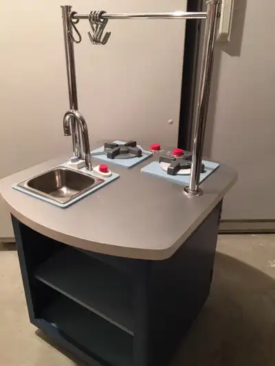 Kitchen play set from Pottery Barn. Solid wood and metal construction. Has sink, stove top, oven, sh...