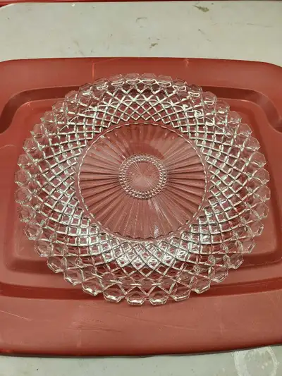 Add a touch of elegance to your table with this vintage clear glass plate, perfect for serving or di...