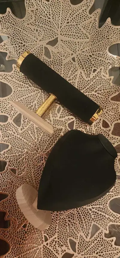 black velvet-and-wood T-bar bracelet/watch display stand and a black bust necklace display stand