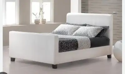 Double white faux leather bed including mattress. Very solid and well built Mattress is like new Non...