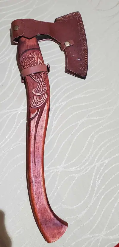 This stunning Viking-inspired decorative axe is a true statement piece. Featuring a beautifully carv...