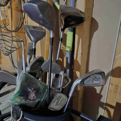 2 golf bags with assortment of clubs, View more