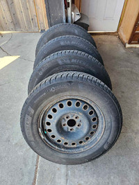 Four Winter tires 235/65 R17 on rims.
