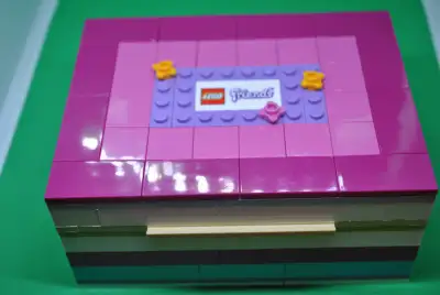 This is LEGO set 40114. The inside of the jewelry box has hooks to hang rings on. There is a small r...