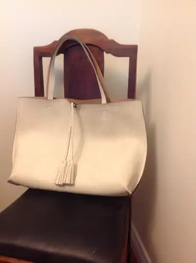 Never used. Light cream coloured Tote Bag with a Carmel coloured interior measuring 13 inches tall b...