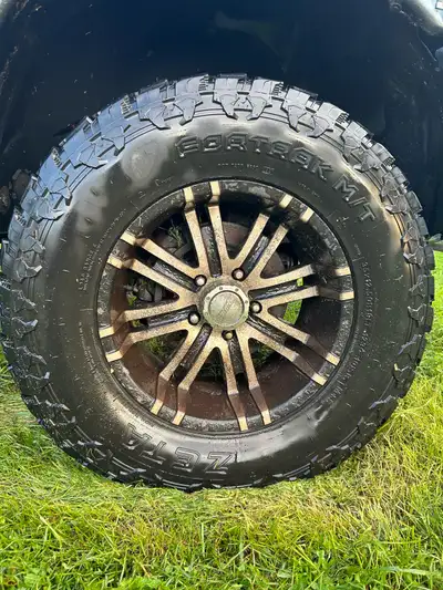 35x12.5x18 Zeta fourtrak MT tires 90% tread under 10,000km on 18” eagle Alloy rims .. rims are flaki...