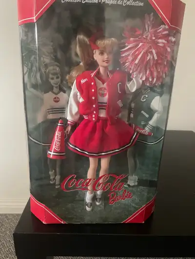 This Coca-Cola Barbie is a collector's edition doll in mint condition, still in its original packagi...