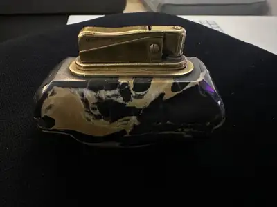 I'm selling a used vintage Zippo table lighter with a striking black marble base, perfect for collec...