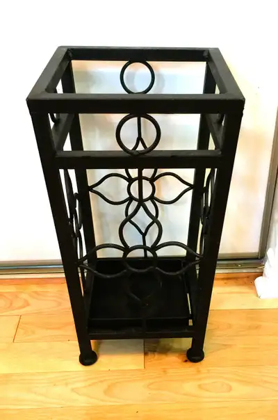 Unique Vintage black iron cane/Umbrella stand. Very sturdy with removable tray in the bottom. Beauti...