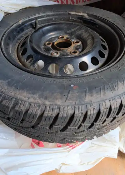 Set of 4, 205/65R15 Uniroyal Tiger Paw Ice Snow 3 winter tires mounted on black steel wheels, lightl...
