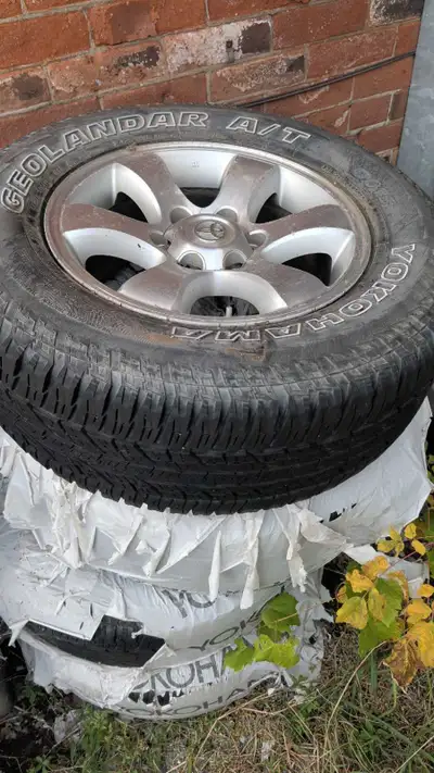 Rims and tires from a 2005 Toyota 4Runner. Tires are Yokohama Geolandar 265/65/17. About 8 years old...