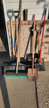 Assorted shovels and brooms
