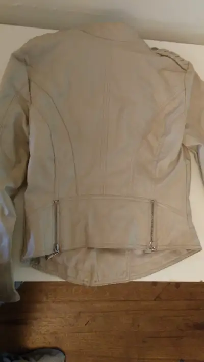 I have a lovely women's jacket for sale, which I believe is faux leather. It's cream coloured, and i...
