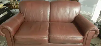 This is a comfortable used couch with a matching chair, featuring a sturdy frame and durable upholst...