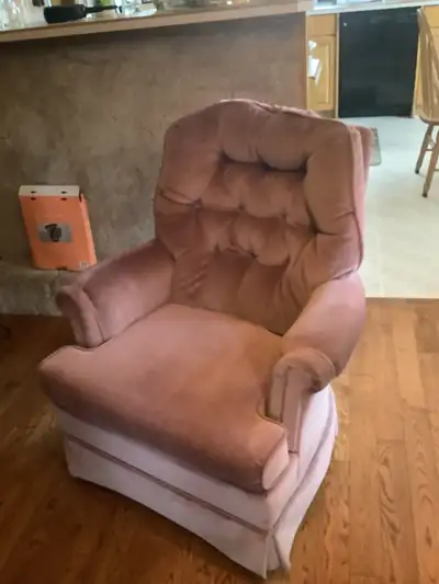 A swivel lounge chair grey/reddish in colour (depending on the light), that would grace any living r...