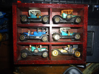 old small collection of older cars (hangs on the wall)