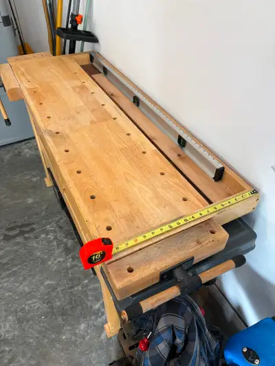 Wood working bench with two vises, one storage drawer, and one shlf. The top is flat/smooth and read...