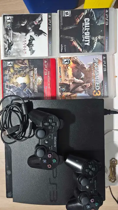 PS3+4 games. 2 duelshock 3 6axis controllers., View more