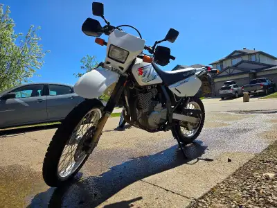 This reliable Suzuki DR650 dual-sport motorcycle is in good condition, featuring a 650cc engine and...