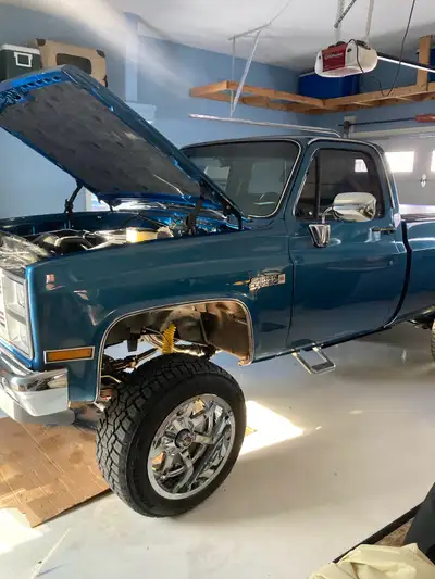 This is a beautifully restored 1981 GMC Square body Sierra Classic pickup truck, featuring a strikin...