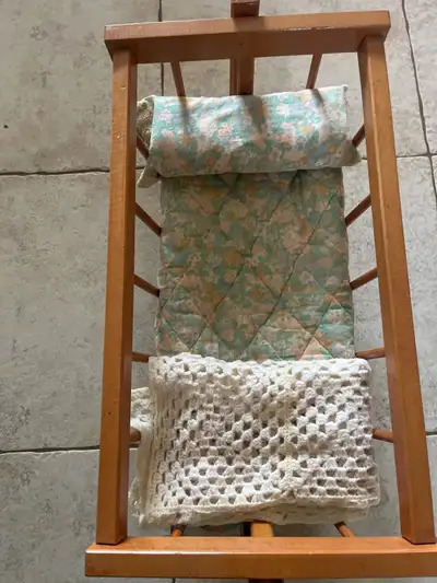 Vintage toy rocking cradle/crib made of wood. Comes with matching pillow and blankets.