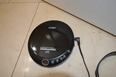 COBY PORTABLE CD PLAYER __ Model CX-CD109 __ Powered by 2 AA batteries, NOT INCLUDED __ comes with c...