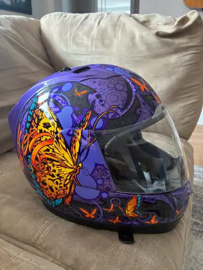 This is a used Icon Chrysalis women's motorcycle helmet, featuring a striking purple butterfly desig...