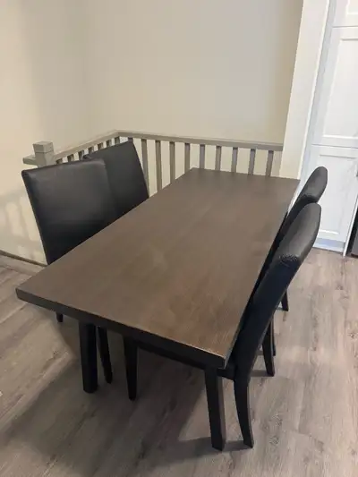 This is an IKEA table with four chairs, perfect for a small dining area or kitchen. The set is in us...