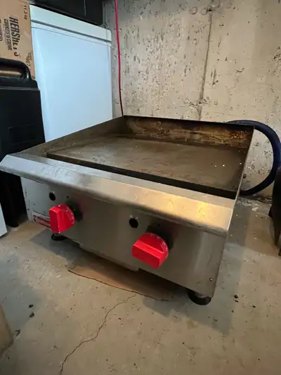 Offering an Omcan countertop gas griddle with 2 burners and a 24-inch cooking surface, perfect for s...
