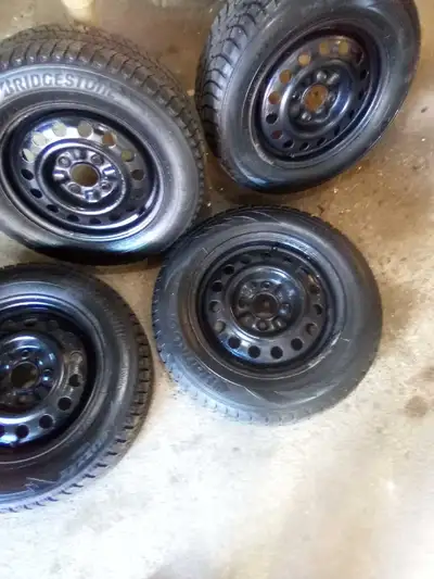 Selling a set of 2008 sentra steel wheels, 2 of the tires used one winter, Bridgestone 195/65r15. Th...