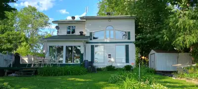 Beachfront house for sale on the Ottawa River. Deadend street, 200 ft of sandy beach. Four bedrooms,...