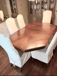 Extendable wood dining table and six chairs.