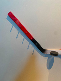 Wall hooks in the shape of a hockey stick